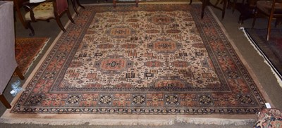 Lot 1283 - A machine made carpet of Ziegler design, The terracotta field with an all over design of vines...