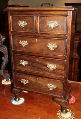 Lot 1295 - A Georgian style mahogany miniature chest of drawers, two short over three long, gilt metal...