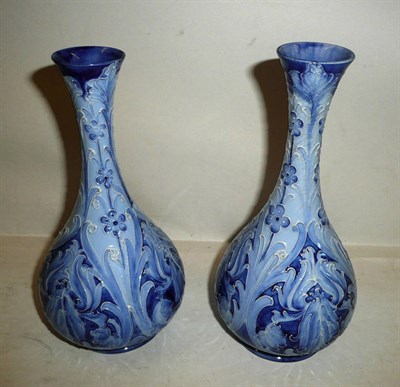 Lot 1497 - A Pair of William Moorcroft Macintyre Florian Iris Pattern Vases, circa 1898, with bulbous base and