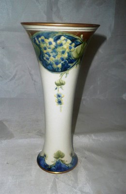 Lot 1498 - A William Moorcroft Macintyre Lilac Pattern Trumpet Vase, circa 1905, on a white ground with...