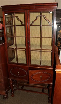 Lot 1316 - An Edwardian mahogany display cabinet in the 18th century style, two glazed doors over twin...