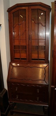 Lot 1322 - An Edwardian oak bureau bookcase, moulded cornice above twin glazed doors, the drum-top bureau with