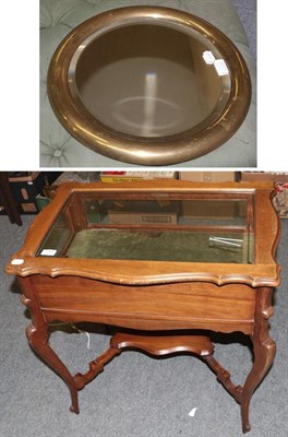 Lot 1334 - A mahogany bijouterie table with shelf stretcher and a brass mirror, 68cm by 44cm by 72cm,...