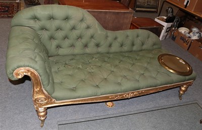 Lot 1337 - A 19th century gilt-framed chaise longue, upholstered in green buttoned fabric (distressed),...