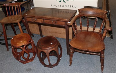 Lot 1340 - A 19th century mahogany fold over tea table together with an elm smokers chair of similar date,...