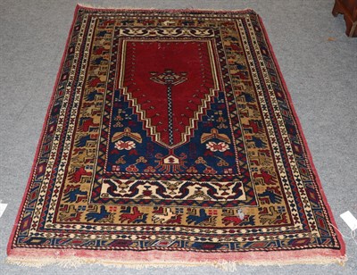 Lot 1347 - An Anatolian Prayer rug, The crimson field beneath the Mihrab enclosed by multiple borders,...