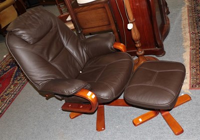 Lot 1349 - A dark brown leather reclining chairs together with matching footstool