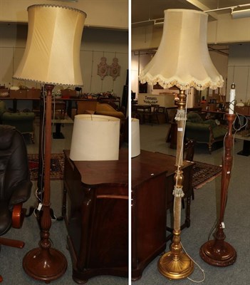 Lot 1351 - A gilt and fabric standard lamp, together with three further mahogany examples (4)