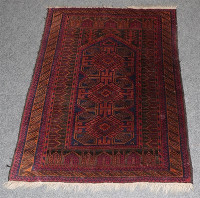 Lot 1362 - A Baluch Prayer rug, the indigo field of hooked medallions beneath the Mihrab enclosed by...