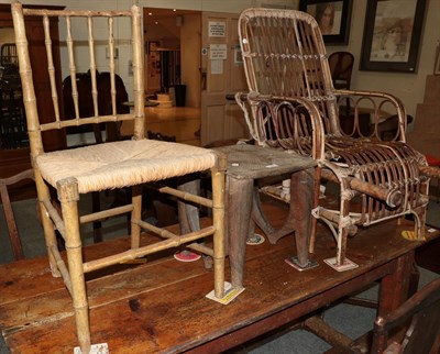 Lot 1383 - An African tribal stool, a bamboo and wicker invalid's chair and a faux bamboo occasional chair (3)