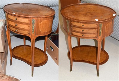 Lot 1397 - A pair of French metal mounted inlaid walnut bedside cabinets of oval tops and with reniform...