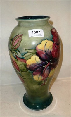 Lot 1507 - A Walter Moorcroft Hibiscus Pattern Vase, circa 1960's, of baluster design, on a green/blue ground