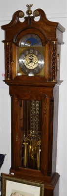 Lot 1405 - A Kieninger strike-silent oak cased longcase clock, the arched dial with silvered chapter ring,...