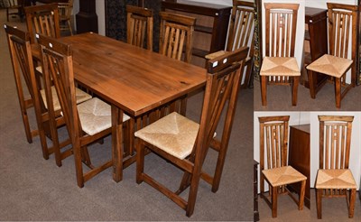 Lot 1421 - An Arts & Crafts style pine dining table, 165cm by 85cm by 78cm high; and ten matching chairs (11)