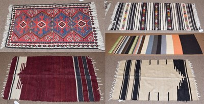 Lot 1437 - A Anatolian Kilim the field with black and white bands containing polychrome medallions framed,...