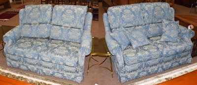 Lot 1441 - A pair of blue upholstered two-seater wing backed sofas, 155cm by 100cm by 88cm high