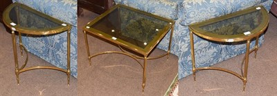 Lot 1442 - A glass-topped brass coffee table, 65cm by 55cm by 49cm high, with two demi-lune nesting...