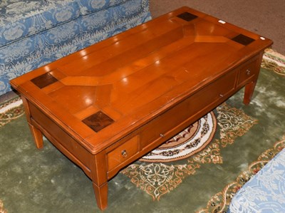 Lot 1444 - A modern coffee table fitted with slides and drawers, 125cm by 65cm by 44cm high