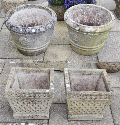 Lot 1457 - A pair of weathered composition half-barrel form planters, decorated with a rose, 57cm diameter...