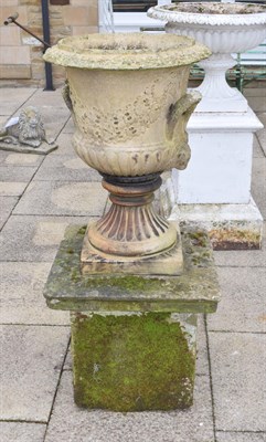 Lot 1459 - An impressive weathered composition garden canpana urn, on a heavily weathered stone plinth