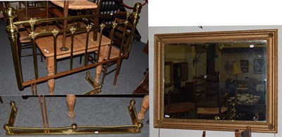 Lot 1466 - A brass double bed-head; a brass fender; and a modern mirror (3)