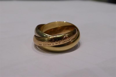 Lot 7 - A Trinity ring, by Cartier, three entwined yellow, rose and white bands, finger size F1/2