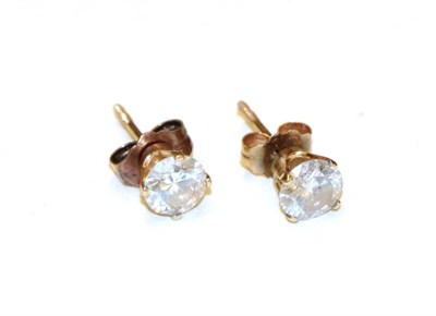 Lot 11 - A pair of diamond solitaire earrings, the round brilliant cut diamonds in yellow claw settings,...