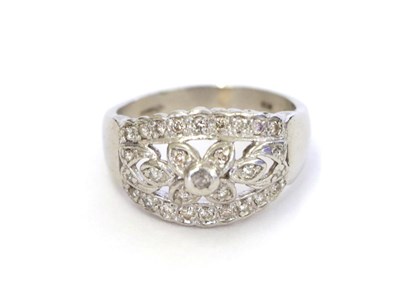 Lot 17 - A platinum diamond ring, the central floral cluster flanked by tapered bars set throughout with...