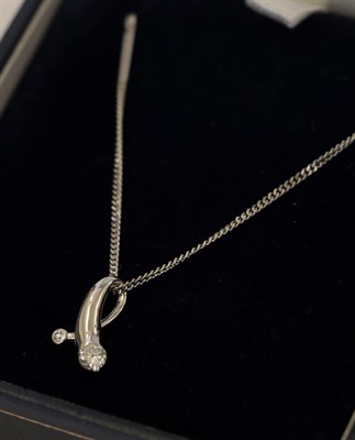 Lot 18 - An 18 carat white gold diamond pendant on an 18 carat white gold chain, the tapered loop...