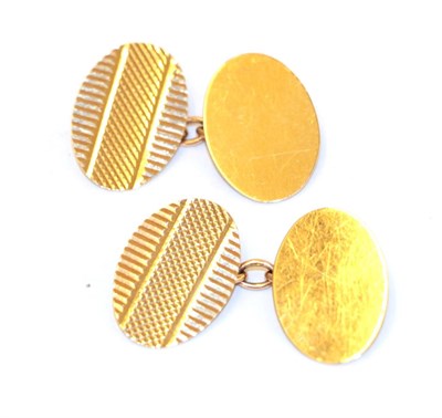 Lot 25 - A pair of 9 carat gold cufflinks, the bright cut engraved oval plaques chain linked to a plain...