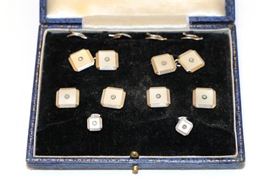 Lot 26 - A cased Art Deco mother-of-pearl and diamond dress stud and cufflink suite, comprising four...
