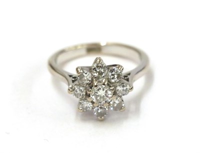 Lot 30 - A diamond cluster ring, the round brilliant cut diamond within a border of smaller round...