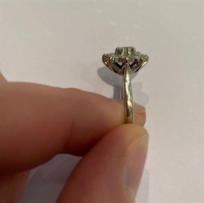 Lot 30 - A diamond cluster ring, the round brilliant cut diamond within a border of smaller round...