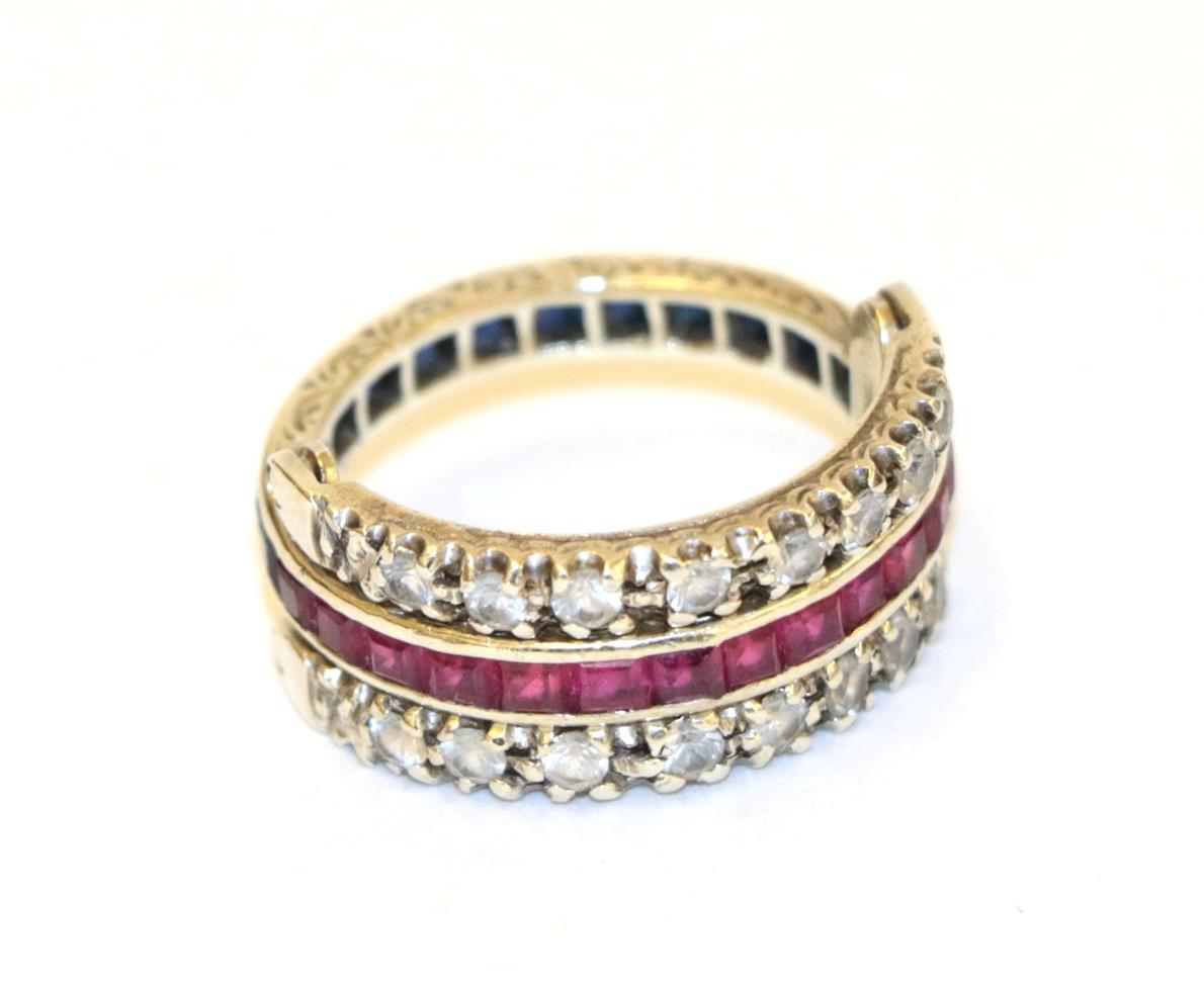 Lot 36 - A white sapphire, synthetic ruby and synthetic sapphire swivel ring, the main band channel set...