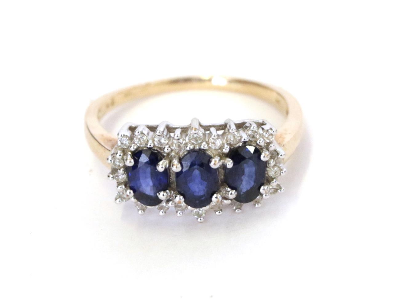Lot 42 - A 9 carat gold sapphire and diamond cluster ring, three oval sapphires within a border of eight-cut