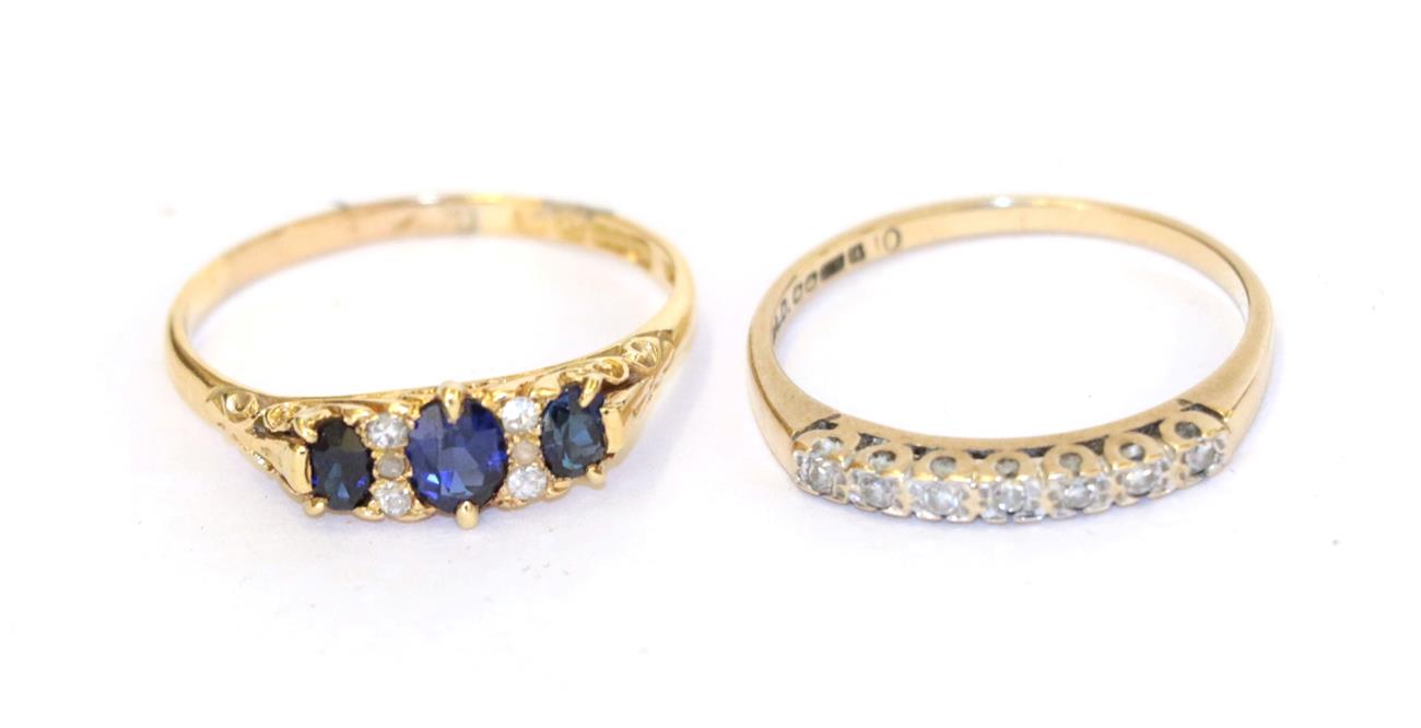 Lot 48 - An 18 carat gold synthetic sapphire and diamond ring, three graduated oval sapphires spaced by...