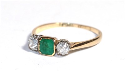 Lot 50 - An emerald and diamond three stone ring, the emerald-cut emerald in a yellow rubbed over...