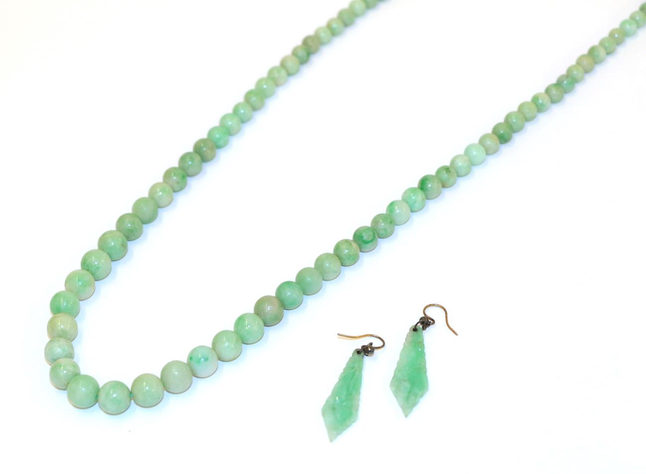 Lot 61 - A jade bead necklace, formed of one hundred and fifteen graduated spherical jade beads, length...