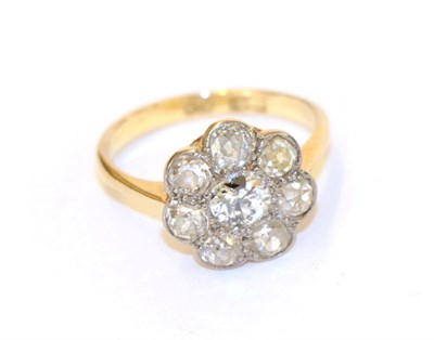 Lot 63 - A diamond cluster ring, the central round brilliant cut diamond within a border of smaller old...