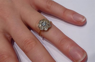 Lot 63 - A diamond cluster ring, the central round brilliant cut diamond within a border of smaller old...