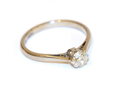 Lot 65 - A diamond solitaire ring, the old cut diamond in a white claw setting, to a tapered shoulder...