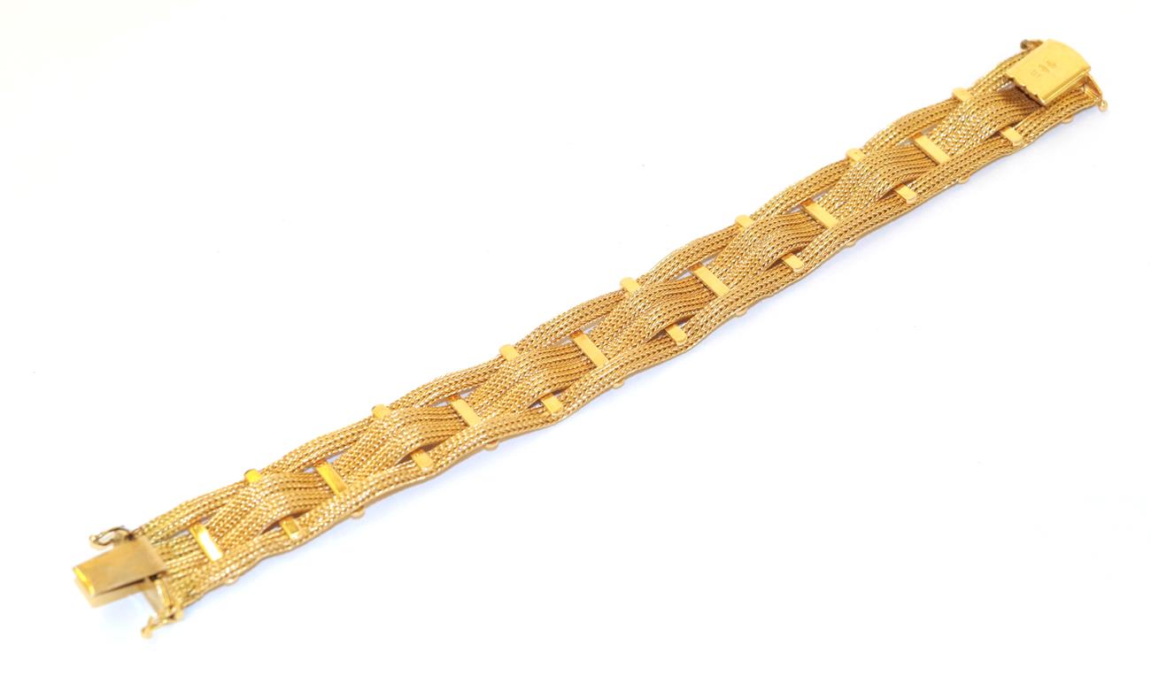 Lot 70 - A fancy link bracelet, four yellow woven chains in an undulating form spaced by plain polished...