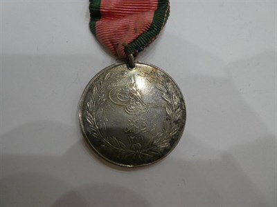 Lot 9 - A Victorian Group of Three Medals, comprising Crimea Medal with clasp SEBASTAPOL, awarded to LIEUT.