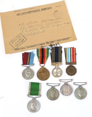 Lot 57 - A Collection of Eight Rhodesian Medals: - Police Reserve Medal to A5918 A/F/R Chiwungwej; For...