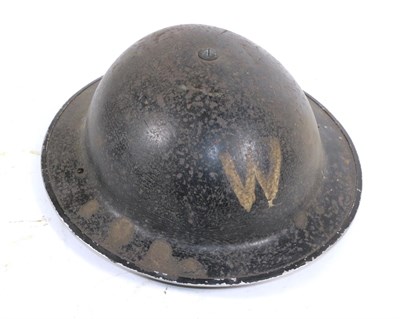 Lot 188 - A British Second World War Brodie Helmet, the black painted steel skull painted W in white...