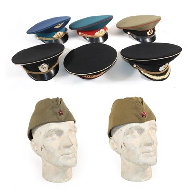 Lot 197 - A Collection of Eight Various Soviet Russian Hats, comprising two Pilotka caps, a Naval hat...