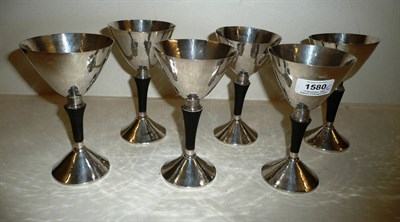 Lot 1580 - A Set of Six Silver Goblets, black nylon stems, with beaten flaring bowls and circular foot,...