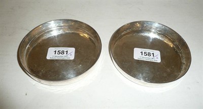 Lot 1581 - A Pair of Modern Silver Circular Coasters, by K.M, hand beaten, London 1991, 11cm diameter, 11oz