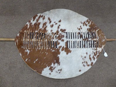 Lot 328 - Two 20th Century Zulu Cow Hide Shields, each of tan and white colouring, of elliptical form,...