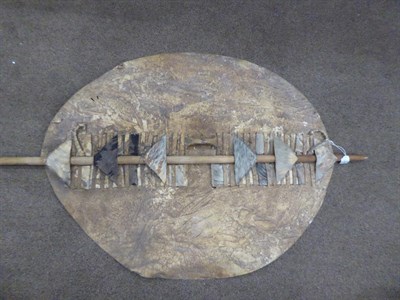 Lot 328 - Two 20th Century Zulu Cow Hide Shields, each of tan and white colouring, of elliptical form,...